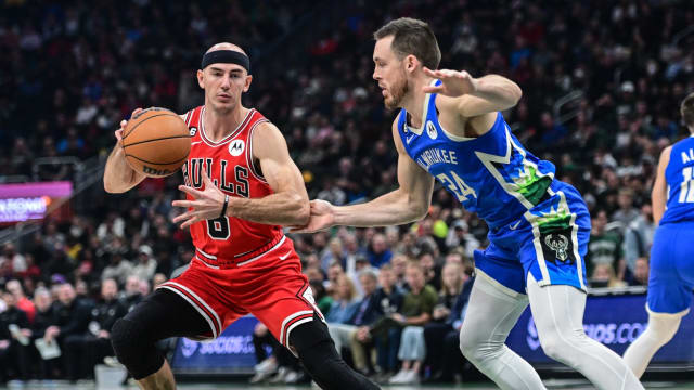 Chicago Bulls guard Alex Caruso (6) is guarded by Milwaukee Bucks guard Pat Connaughton (24) 